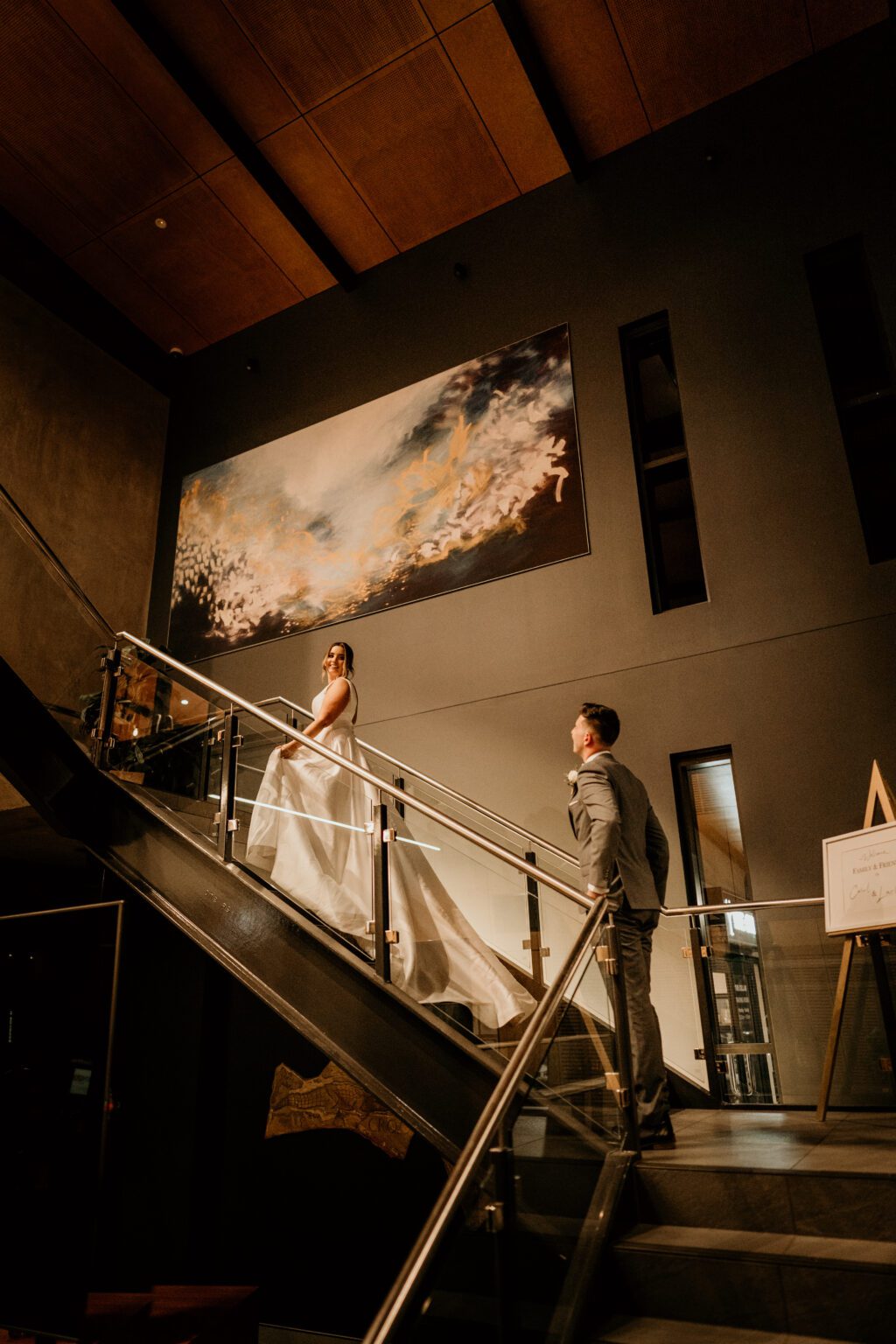 Bride and Groom walking up the stairs to the wedding venue